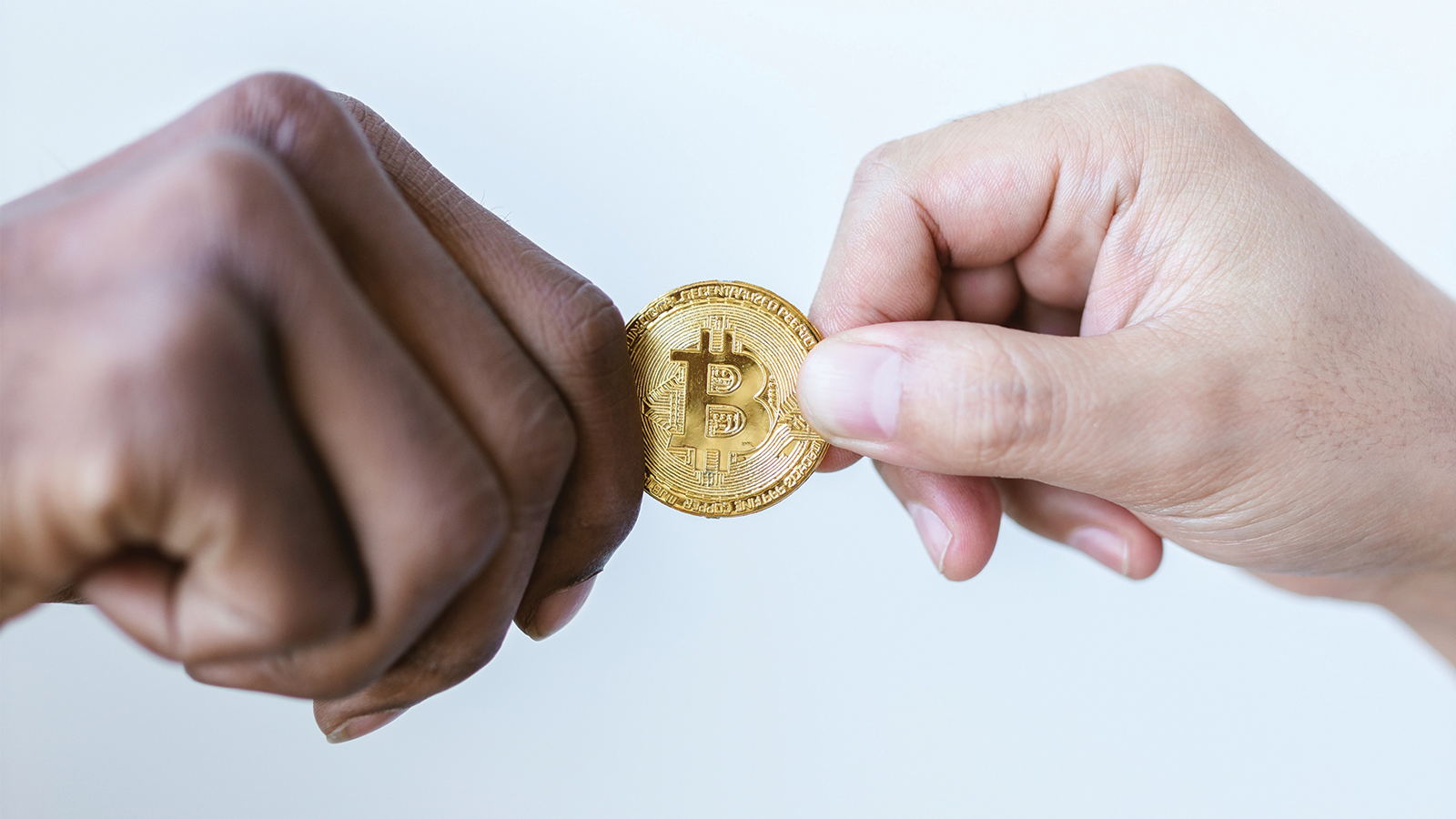 two people holding a 'bitcoin'